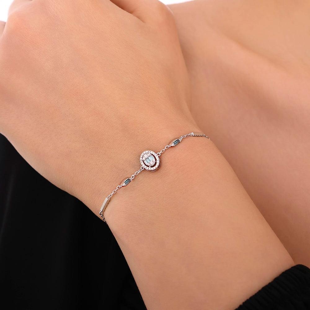 Elegant silver bracelet with oval gemstone and diamond accents on a woman's wrist