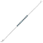 White gold tennis bracelet with alternating deep blue and clear gemstones on white background